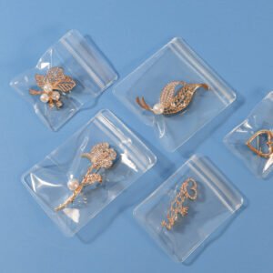 Clear PVC jewelry ziplock bags displaying earrings, rings and necklace charms