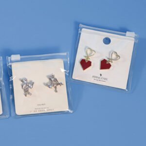 PVC jewelry zipper pouches with white sliders holding earring display cards
